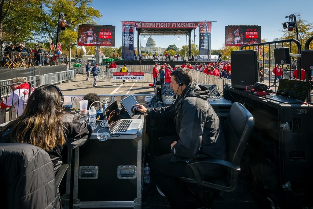 Broadcast crew preparing technical equipment on a beautiful day in DC for the championship parade.