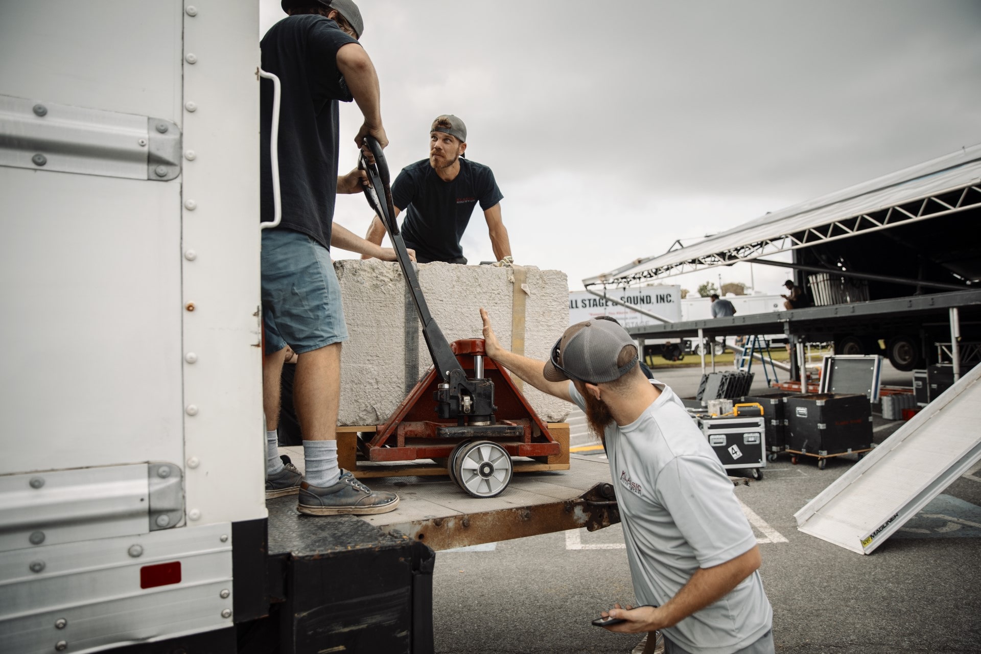 event staff unloads concrete ballast from the box truck