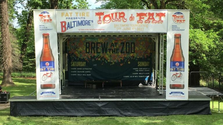 Mobile stage rental with full banner package for a beer and wine festival at the Maryland Zoo in Baltimore.