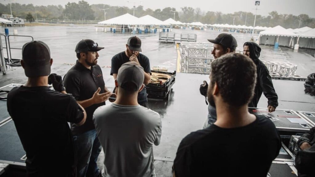 the Production crew leader gathers the technicians to discuss the plan for the day