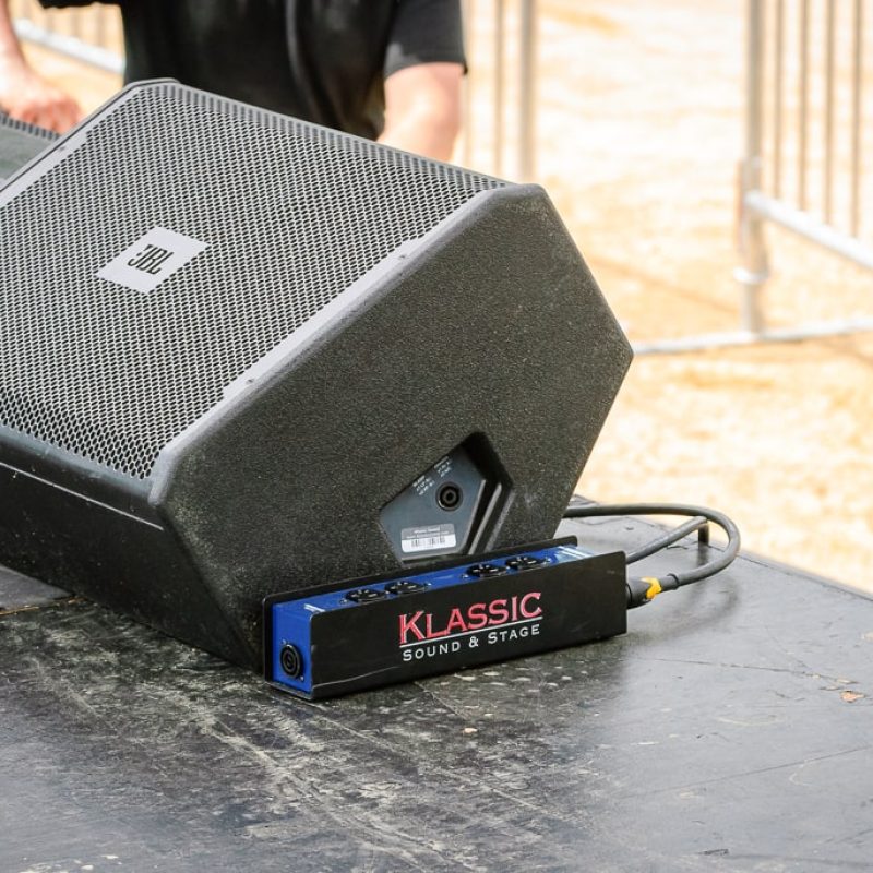 custom stage power box sitting next to a 15 inch bi-amp capable monitor speaker